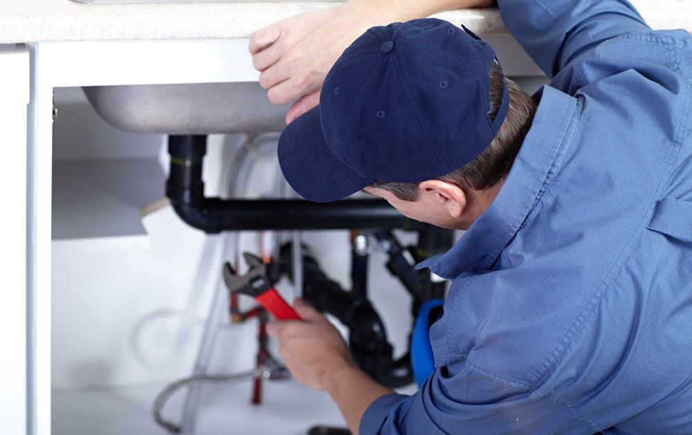 One of our plumbing team members performing drain cleaning services in Mississauga, ON